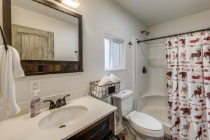 a bathroom with a sink and a toilet and a shower at Kalispell Cabin 28 Miles to Glacier National Park! in Kalispell +18 photos