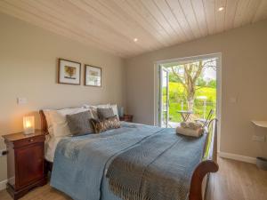 a bedroom with a bed and a large window at Kites Nest-Qu7488 in Highgate