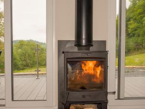 a fireplace in front of a window with flames at Kites Nest-Qu7488 in Highgate +22 photos