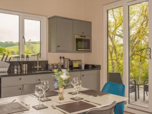 a kitchen with a table with wine glasses on it at Kites Nest-Qu7488 in Highgate