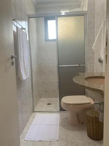 a bathroom with a shower and a toilet at Refúgio em Ubatuba - Perto de tudo in Ubatuba