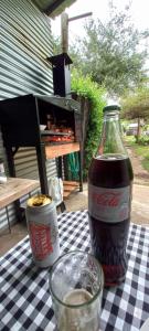 a bottle of cocacola sitting on a checkered table at Kasty in Piriápolis