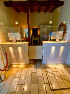 a room with two counter tops with lights on it at La Siègià Resort spa in Massa Marittima