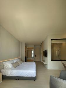 a bedroom with a large white bed and a couch at Chinatown Heritage, Chinatown Main road in Samphanthawong +15 photos