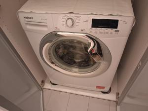 a washing machine sitting on top of a shelf at Bilocale comodamente collegato con centro Milano in Garbagnate Milanese