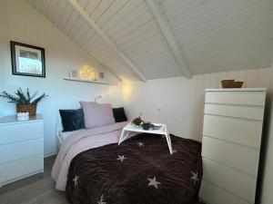 ein Schlafzimmer mit einem Bett und einem Tisch darauf in der Unterkunft Ferienhaus Hein Mück in Glücksburg
