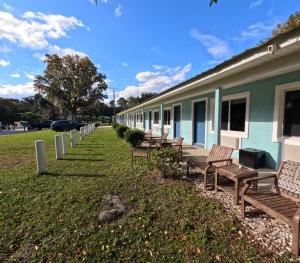 eine Reihe von Bänken an der Seite eines Gebäudes in der Unterkunft Porky's Lodge, Bar & Grill in Georgetown
