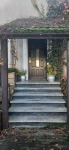 an entrance to a house with stairs leading to a door at Apartament na doby in Poznań
