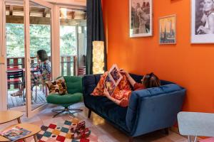a woman laying on a couch in a living room at Chèvreroche in La Bresse +1 photo