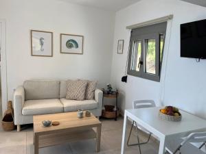 a living room with a couch and a table at Agia Fotia Holiday House in Kerames