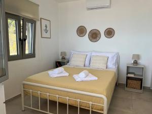 a bedroom with a bed with towels on it at Agia Fotia Holiday House in Kerames