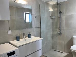 a bathroom with a sink and a shower at Agia Fotia Holiday House in Kerames +20 photos