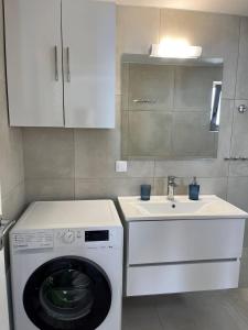 a kitchen with a washing machine and a sink at Agia Fotia Holiday House in Kerames