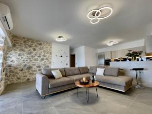 a living room with a couch and a table at Ocean Bliss Villa, By Hellocrete in Kerames