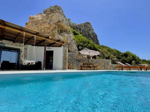 a house with a swimming pool with a basketball hoop at Ocean Bliss Villa, By Hellocrete in Kerames