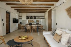 a living room with a white couch and a table at ArtOikia Luxury Villas, By Hellocrete in Saktoúria