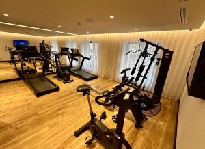 a gym with several exercise bikes in a room at Best Western Plus Crystal, Hotel,Bar & Spa in Nancy +92 photos