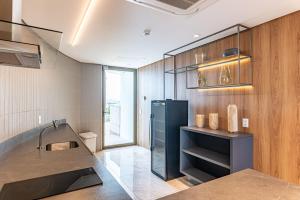 a kitchen with a sink and a refrigerator at Vista Incrível para o Rio e Mar - PC907 in Recife