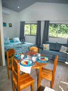 a living room with a table and a couch at Luxury Apartments Nauyaca by Paradiselodge in Platanillo