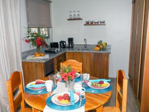 a table with plates of fruit on it in a kitchen at Luxury Apartments Nauyaca by Paradiselodge in Platanillo +4 photos