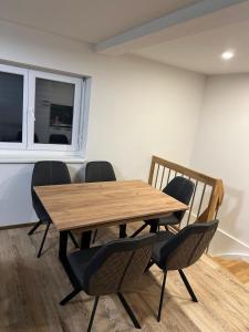 a wooden table and chairs in a room at Alpina Apartment Premium in Feldkirch