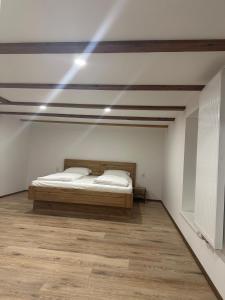 a bedroom with a bed and lights on the ceiling at Alpina Apartment Premium in Feldkirch