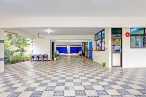 an empty room with a tile floor and windows at Super Collection O Beach Road Near GITAM in Visakhapatnam