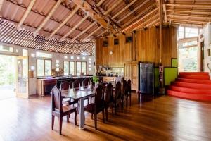 a dining room with a table and chairs and a kitchen at Poolvilla in Platanillo +38 photos