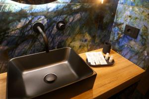 a sink with a faucet on top of a wooden table at Nenna's Suite Room in Scafati