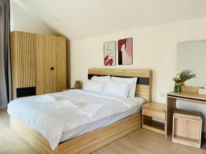a bedroom with a large bed with white sheets at Sandline Cabin Bangtao Just 20m from the Beach in Bang Tao Beach