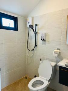 a bathroom with a toilet and a shower at Sandline Cabin Bangtao Just 20m from the Beach in Bang Tao Beach