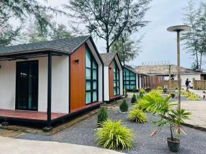 a row of houses with plants in a courtyard at Sandline Cabin Bangtao Just 20m from the Beach in Bang Tao Beach