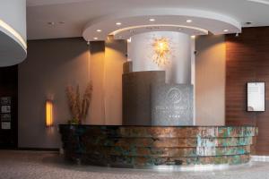 a lobby with a reception desk in a building at Hotel Warszawianka in Jachranka