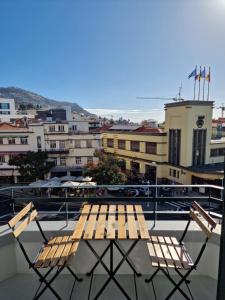 a wooden bench sitting on top of a balcony at Market Downtown T3 in Funchal