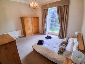 a bedroom with a bed and a window at Hillside House in Saline