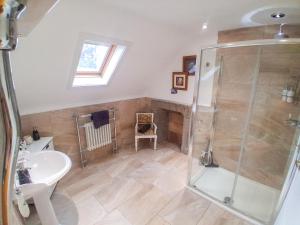 a bathroom with a shower and a sink at Hillside House in Saline +15 photos