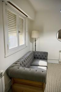 a couch in a living room with a window at Dpto SAN MARTIN in Azul