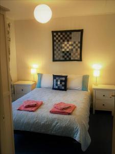 a bedroom with a bed with two towels on it at Ardshiel in Foyers