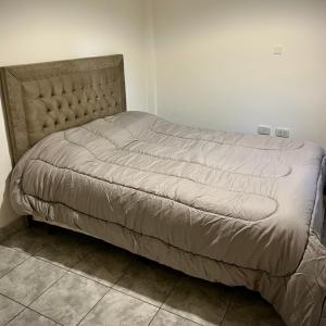 a large bed in a room with at Dpto SAN MARTIN in Azul