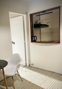 a room with a white door and a table and a chair at Dpto SAN MARTIN in Azul