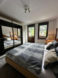 a bedroom with a large bed and two windows at Boardwalk center in Mayrhofen