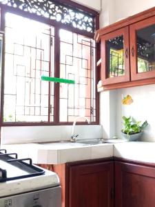 a kitchen with a sink and a window at Kiyara Holiday Villa in Ambalangoda +46 photos