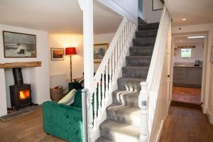 a winding staircase in a home with a fireplace at Amesbury Newport, Pembrokeshire in Newport Pembrokeshire