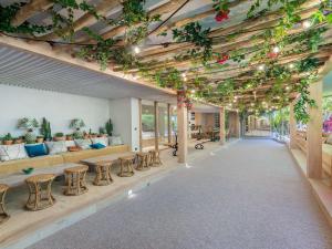 a living room with tables and chairs and plants at Chalet de luxe à Courchevel avec piscine et personnel - FR-1-562-71 in Courchevel