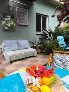 a table with a plate of fruit on top of it at Cascade et Paille-en-queue - Studio in Hell-Bourg
