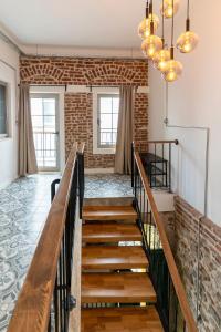 a staircase in a room with a brick wall at Historic Izmir Home in Old Town Heart in Konak