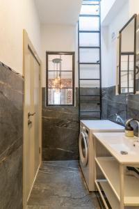 a bathroom with a sink and a washing machine at Historic Izmir Home in Old Town Heart in Konak +11 photos