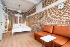 a living room with a brick wall and a couch at Historic Izmir Home in Old Town Heart in Konak