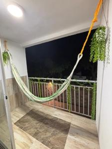 a hammock hanging from the side of a balcony at BAM - Hospedajes in Santa Marta +24 photos