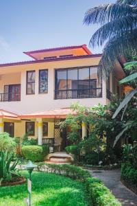 a house with a garden in front of it at Cabatales - 3BHK Villa Near Candolim Beach in Candolim